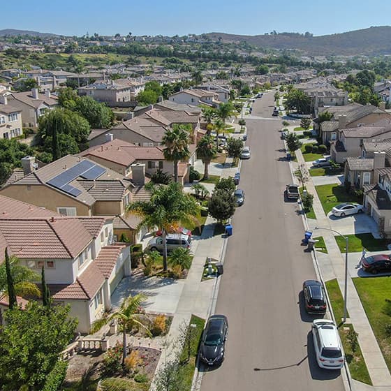 Rows of houses in a neighborhood close to mountains.