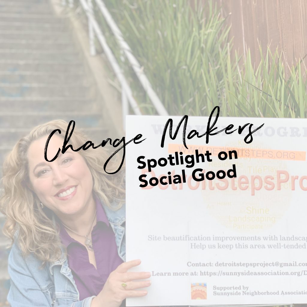 Woman holding sign with messaging in front of Stairs.